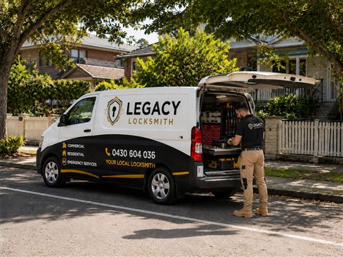 Legacy Locksmith branded van parked on a residential street